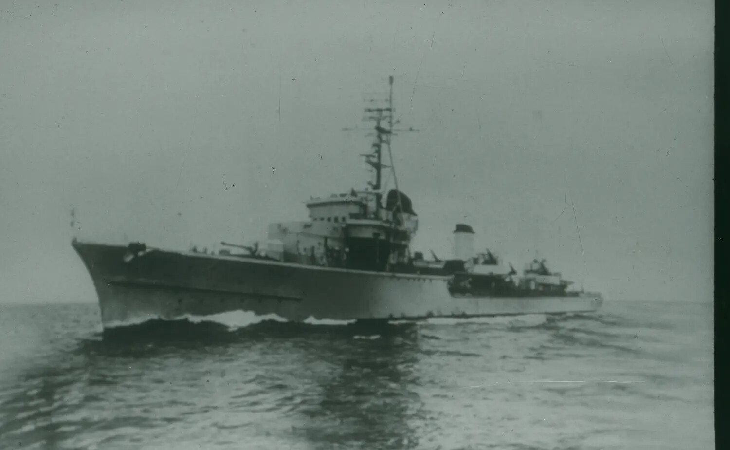 World War II-Era Warship Underway at Sea, Port Bow View