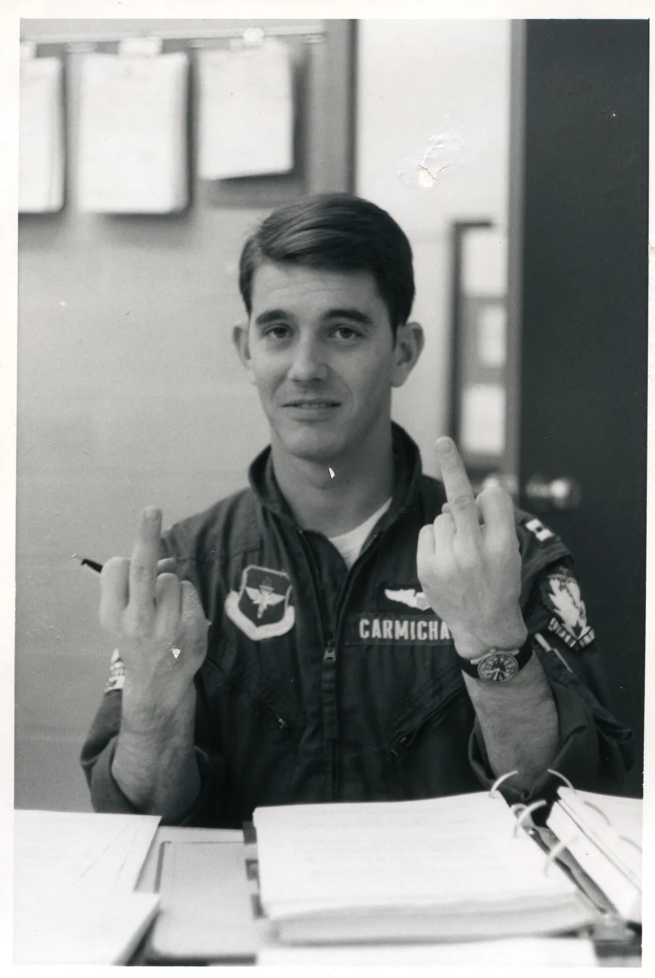 Portrait of Air Force Pilot Carmichael Making an Irreverent Gesture, Squadron Office