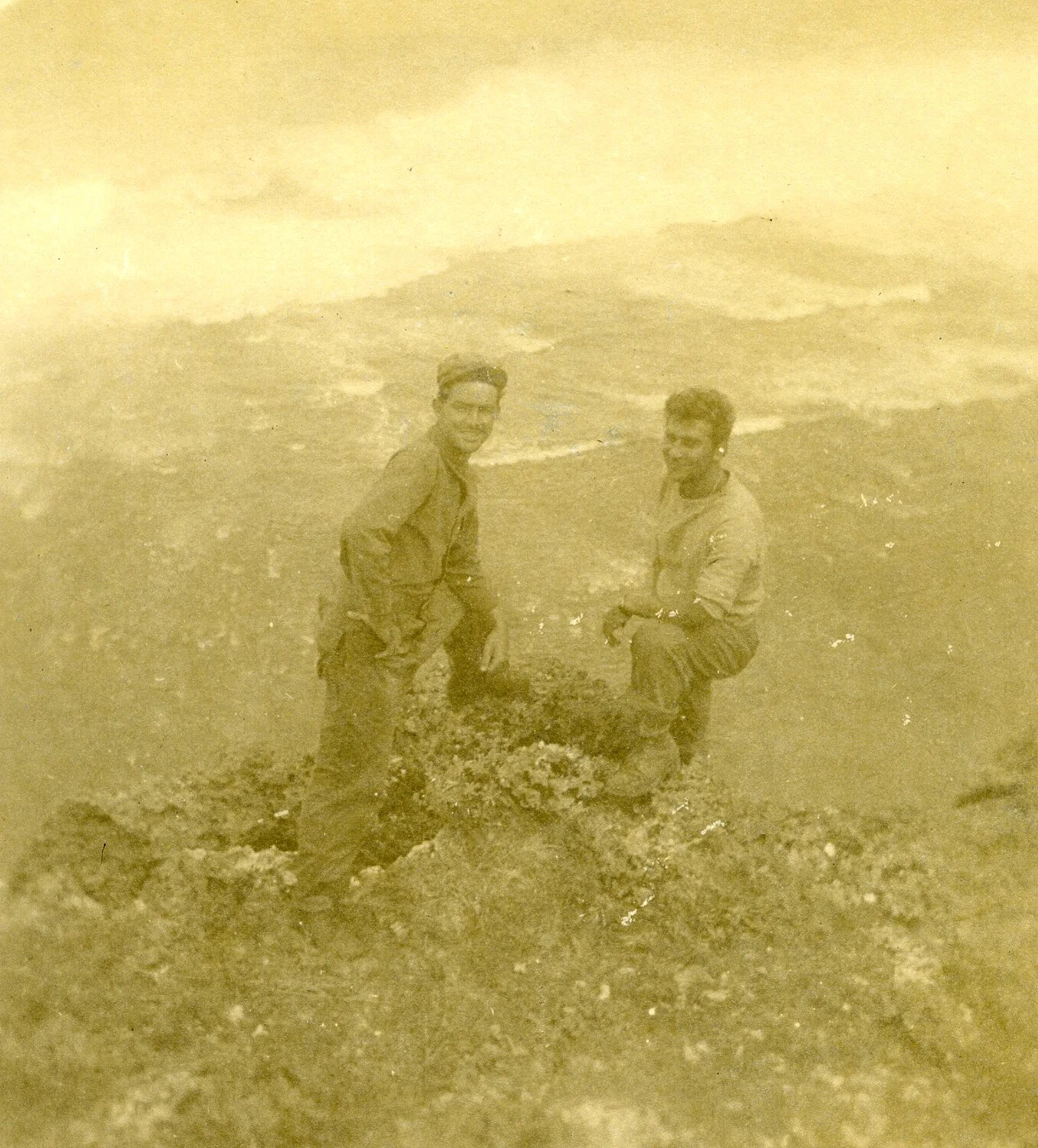 Two Servicemen Crouching on a Coral Outcrop, Island Terrain