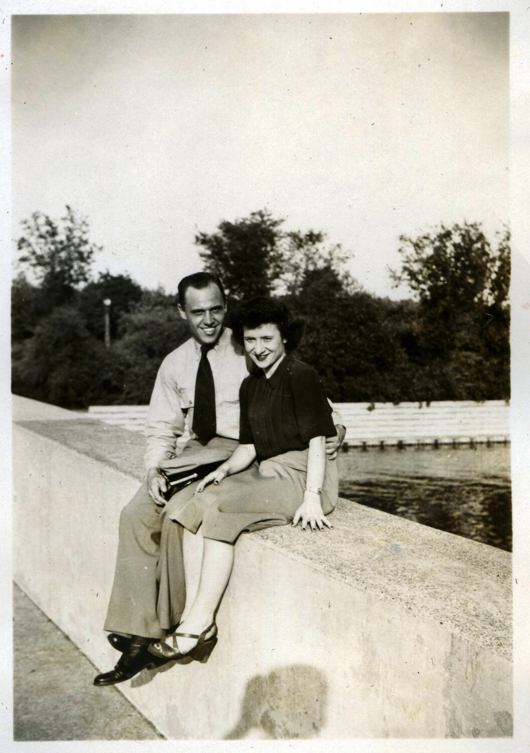 Informal Portrait of a Couple Seated on a Reservoir Wall, Korean War Era