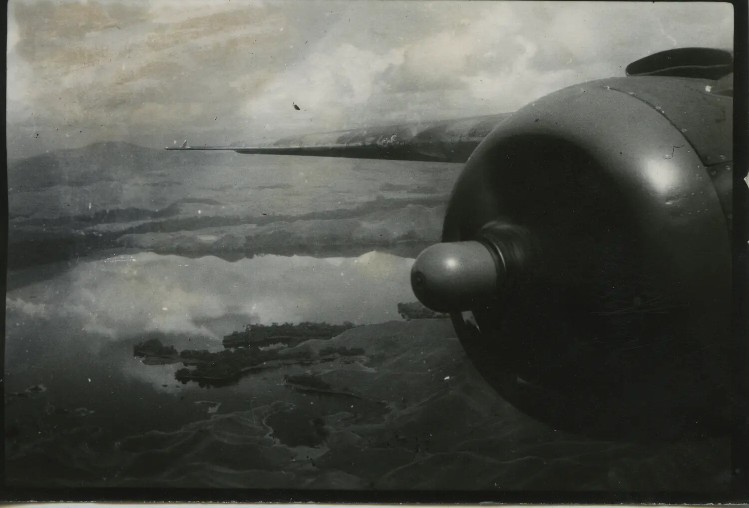 In-Flight View of a B-25 Mitchell Engine Nacelle Over a Pacific Coastline