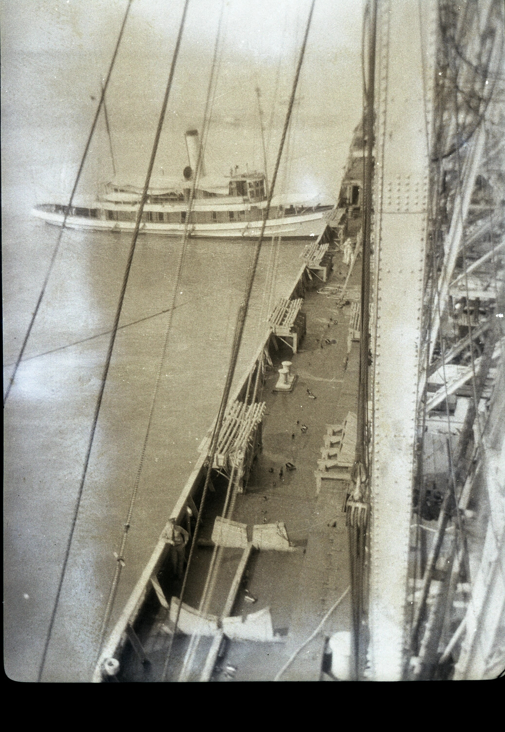 Elevated View of Ship's Deck and Rigging with Nearby Steamer, China, 1930s