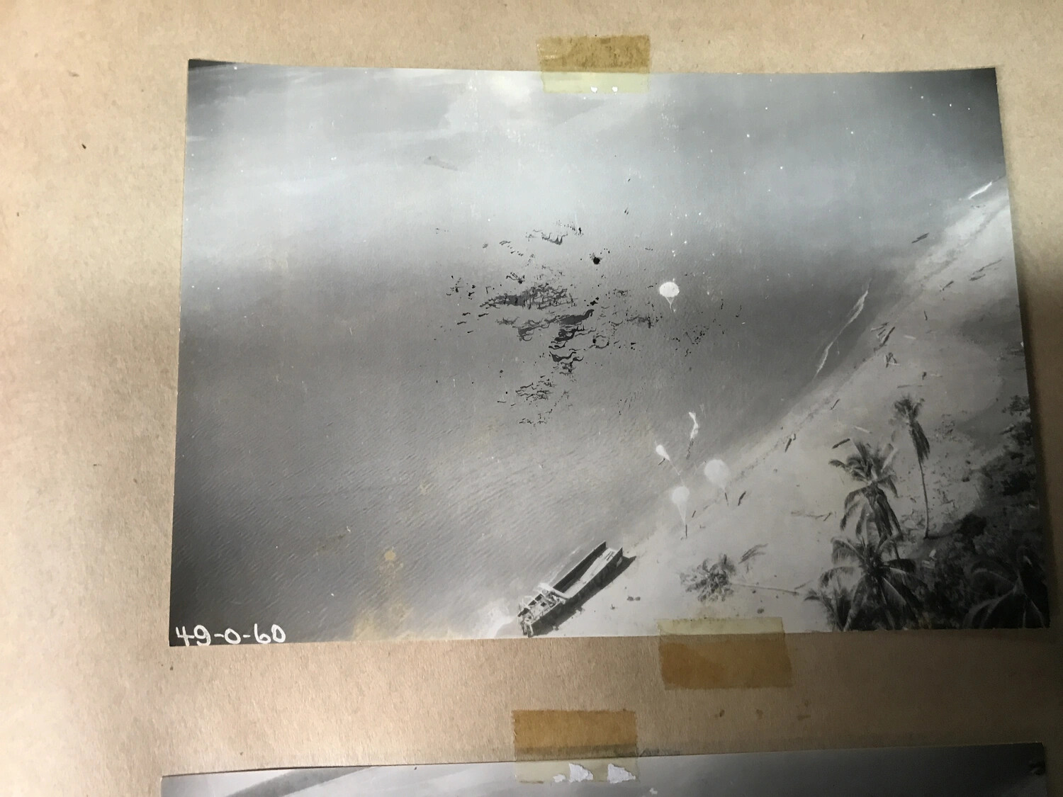 Album Page: Parafrag Bombs Descending Over New Guinea Beach, with Original Frame Number