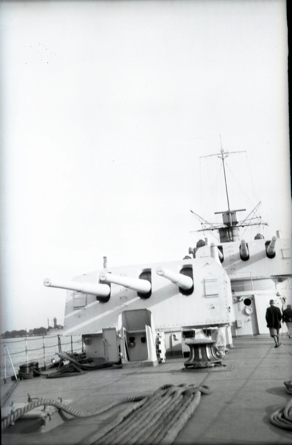 Triple Gun Turret and Superstructure of a WWII-Era Light Cruiser in Harbor