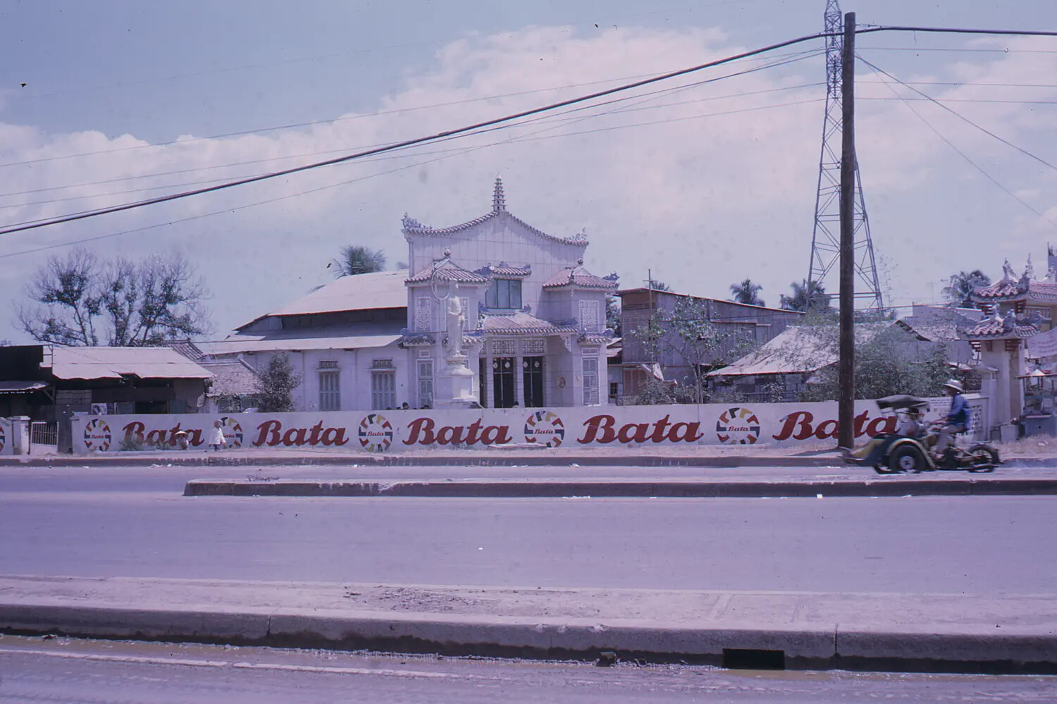 Vietnamese Street Scene with 'Bata' Advertising Wall and Pagoda-Style Building — South Vietnam, 1968