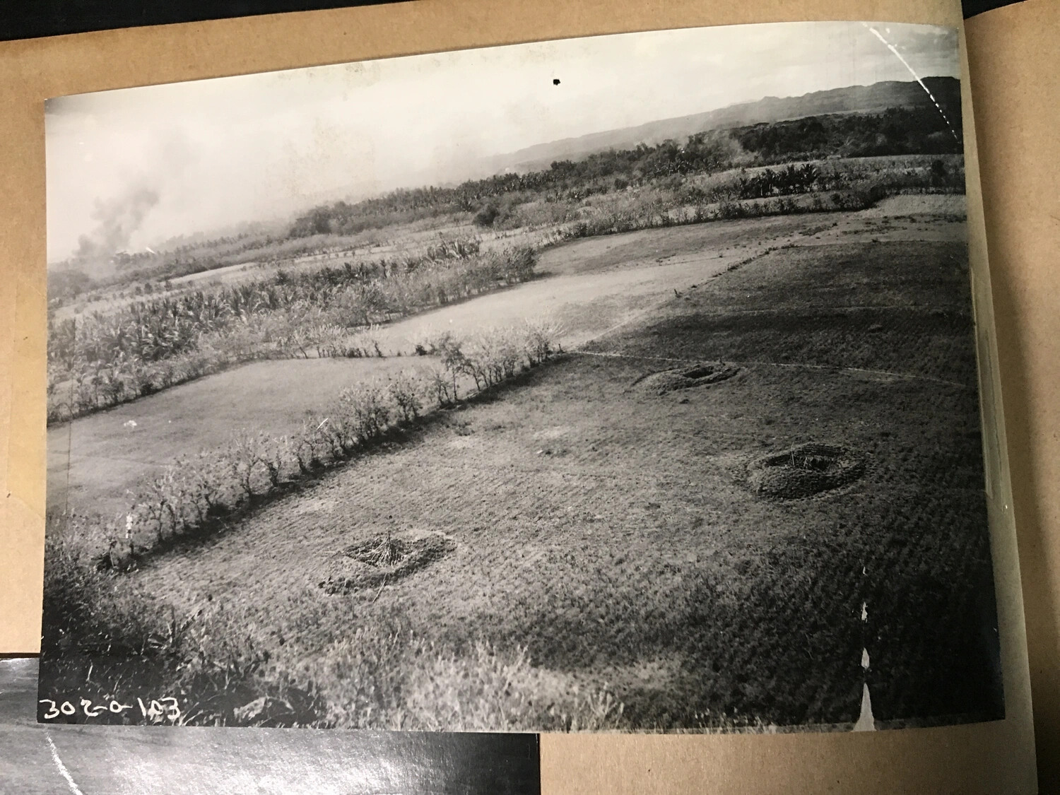 Album Print: Small Craters or Pits in Cultivated Field with Distant Smoke, Negative Number Visible