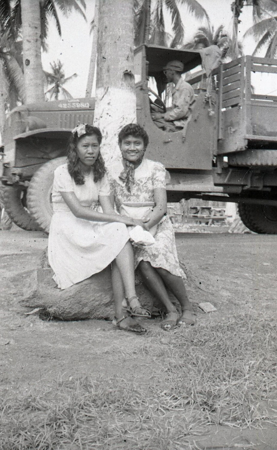 Two Filipina Women Seated by a US Army Truck -- Luzon, Philippines, WWII Era