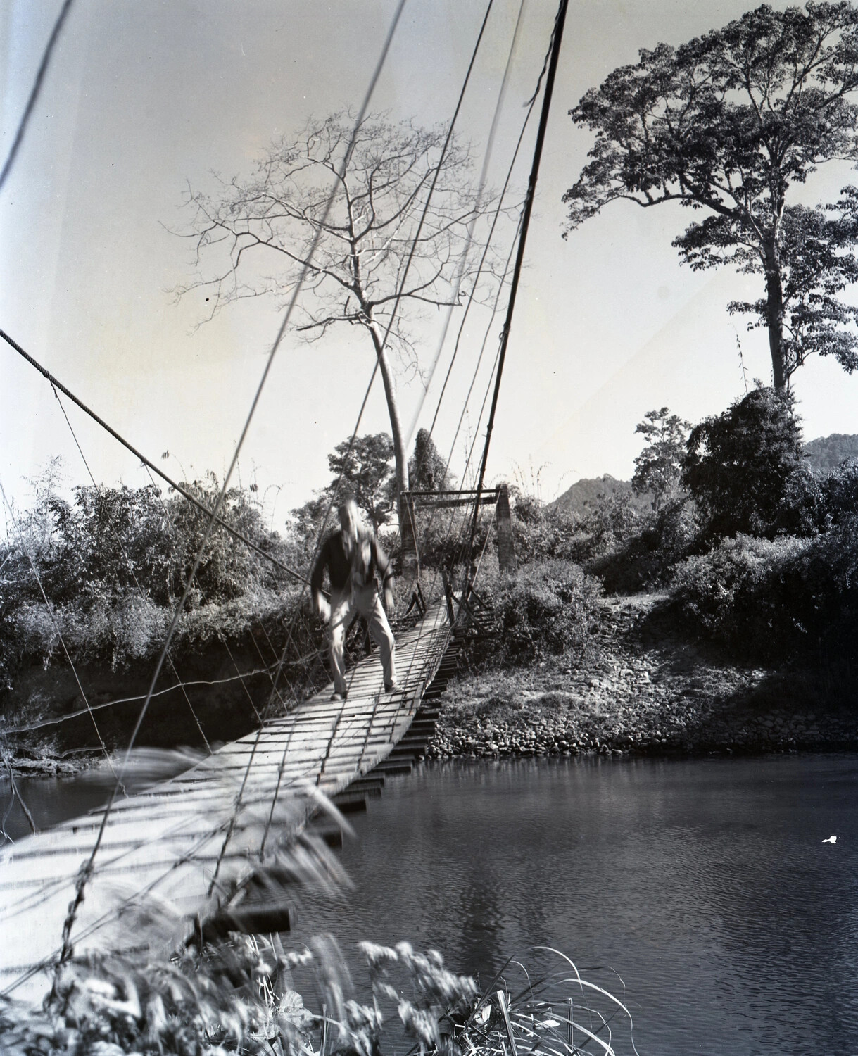 Serviceman Crossing Wire Suspension Footbridge, China-Burma-India Theater, WWII