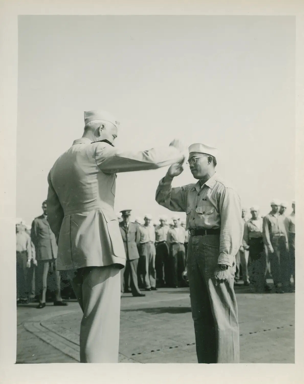 Formal Salute Exchange During a Flight Deck Ceremony Aboard USS Petrof Bay (CVE-80)