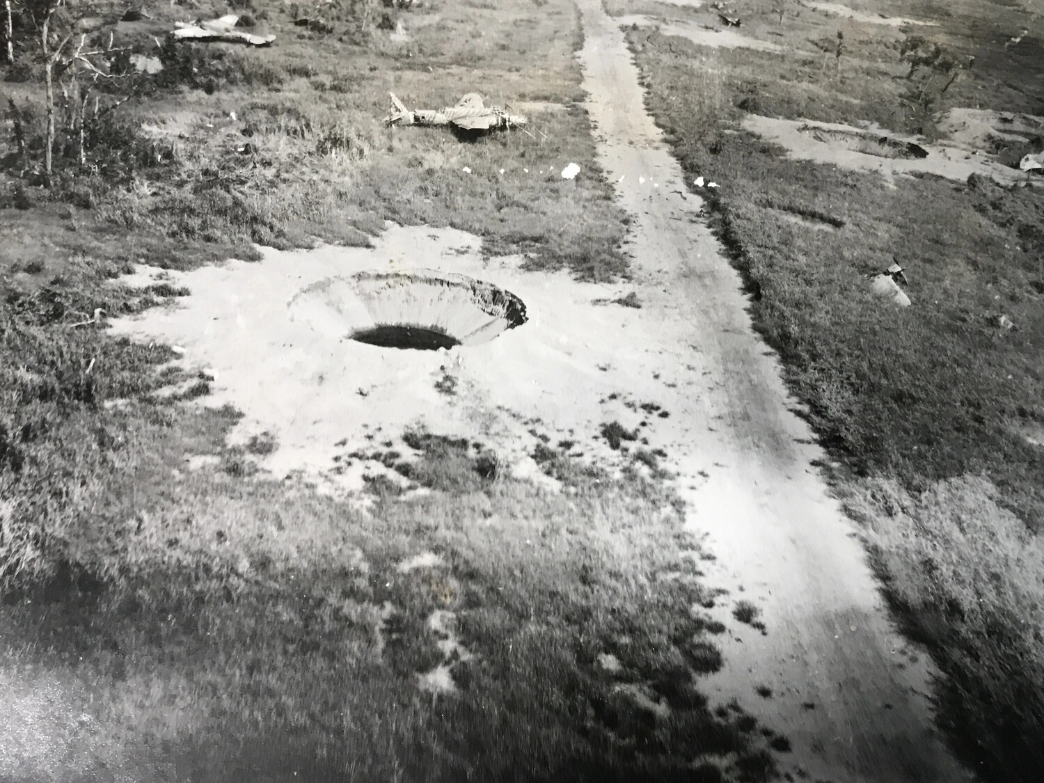 Fresh Bomb Crater Beside Airfield Access Road, New Guinea Strike Sequence