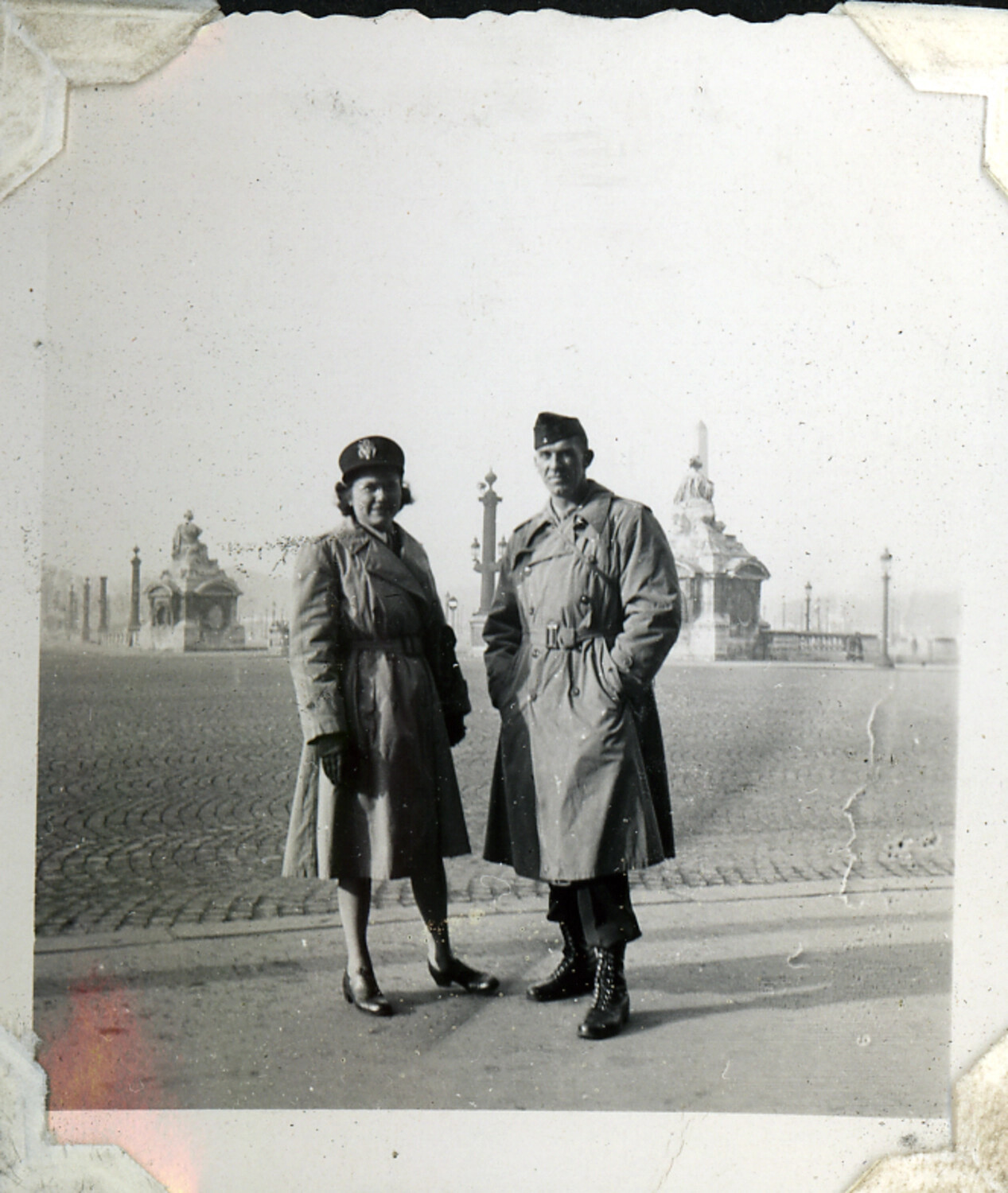 Servicemember and Companion in Overcoats at a European Plaza (Possibly Place de la Concorde, Paris)