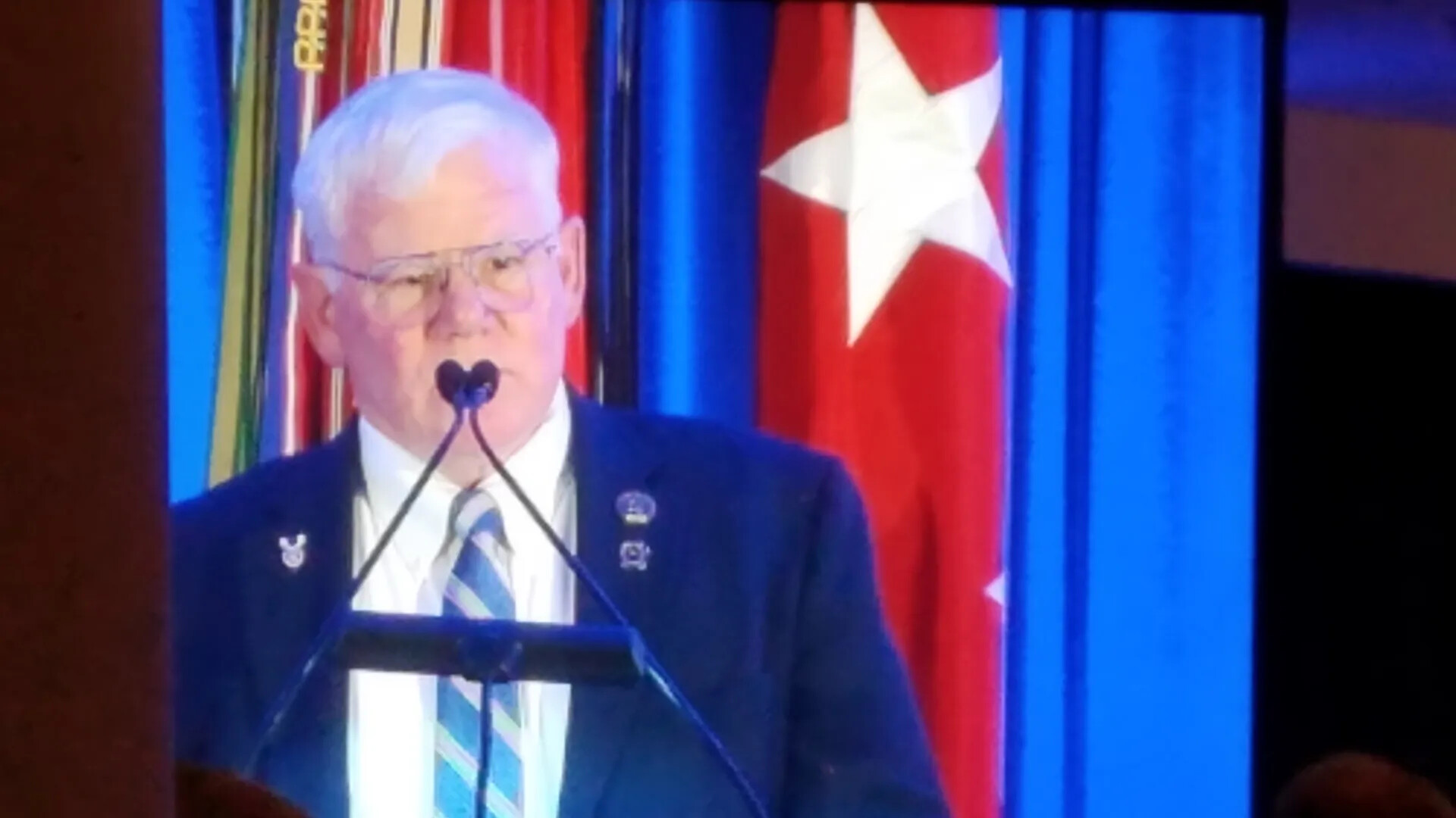 Speaker at Lectern During Medal of Honor Reception Banquet, October 22, 2017 (Photographed from Video Screen)