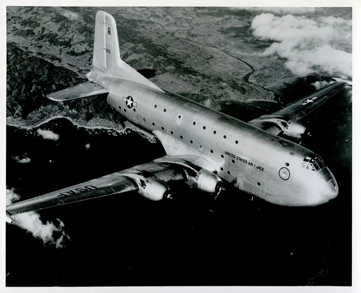 Douglas C-124 Globemaster II Heavy Transport Aircraft in Flight Over Coastline, USAF Publicity Photograph