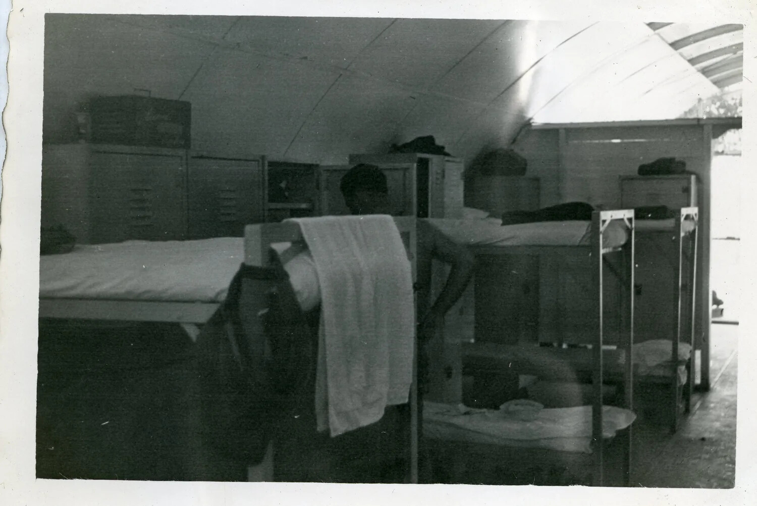 Interior View of Quonset Hut Barracks with Serviceman and Bunks, VR-6 Squadron, Agana, Guam