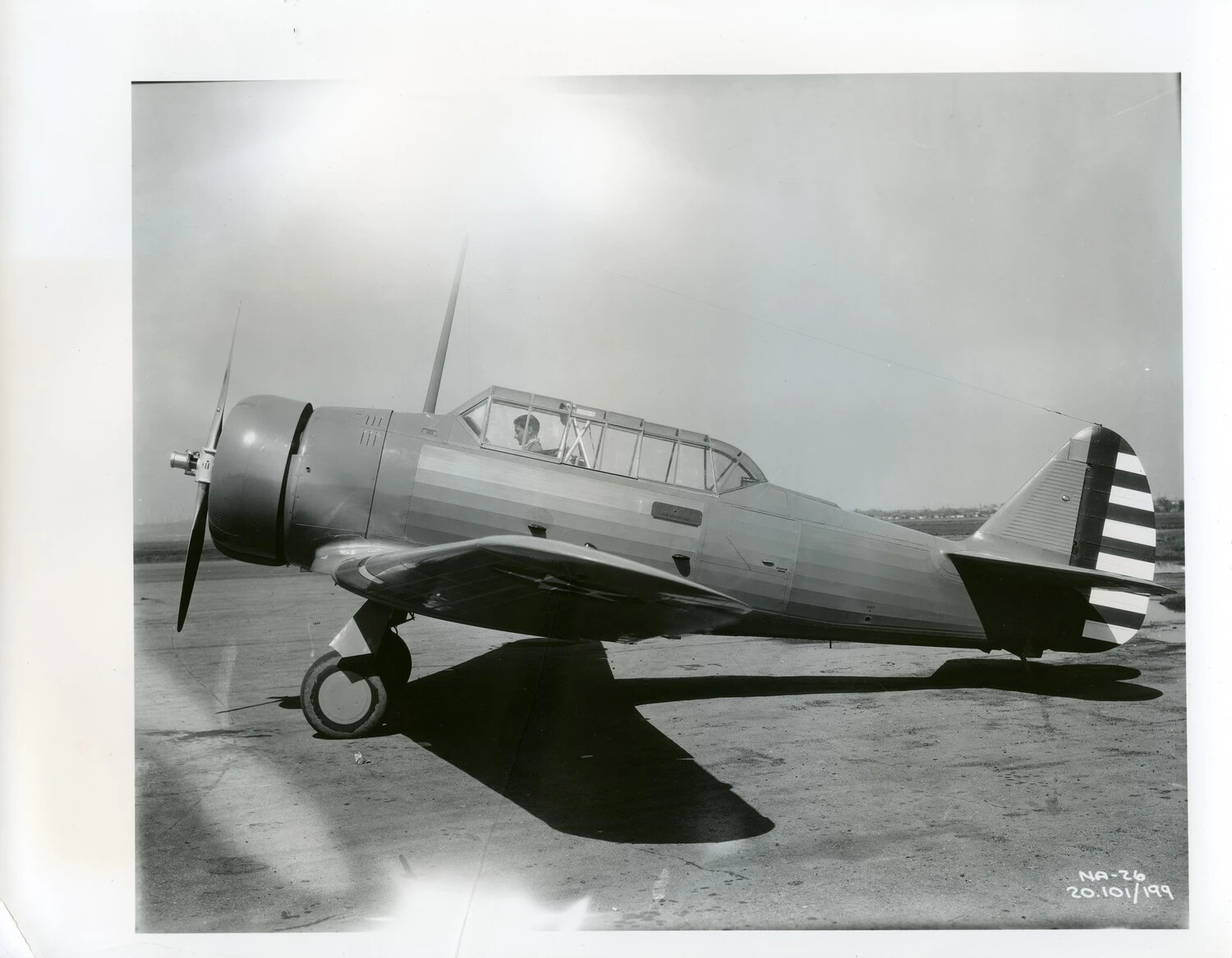 North American NA-26 Basic Trainer Aircraft on Ramp, Pilot in Cockpit