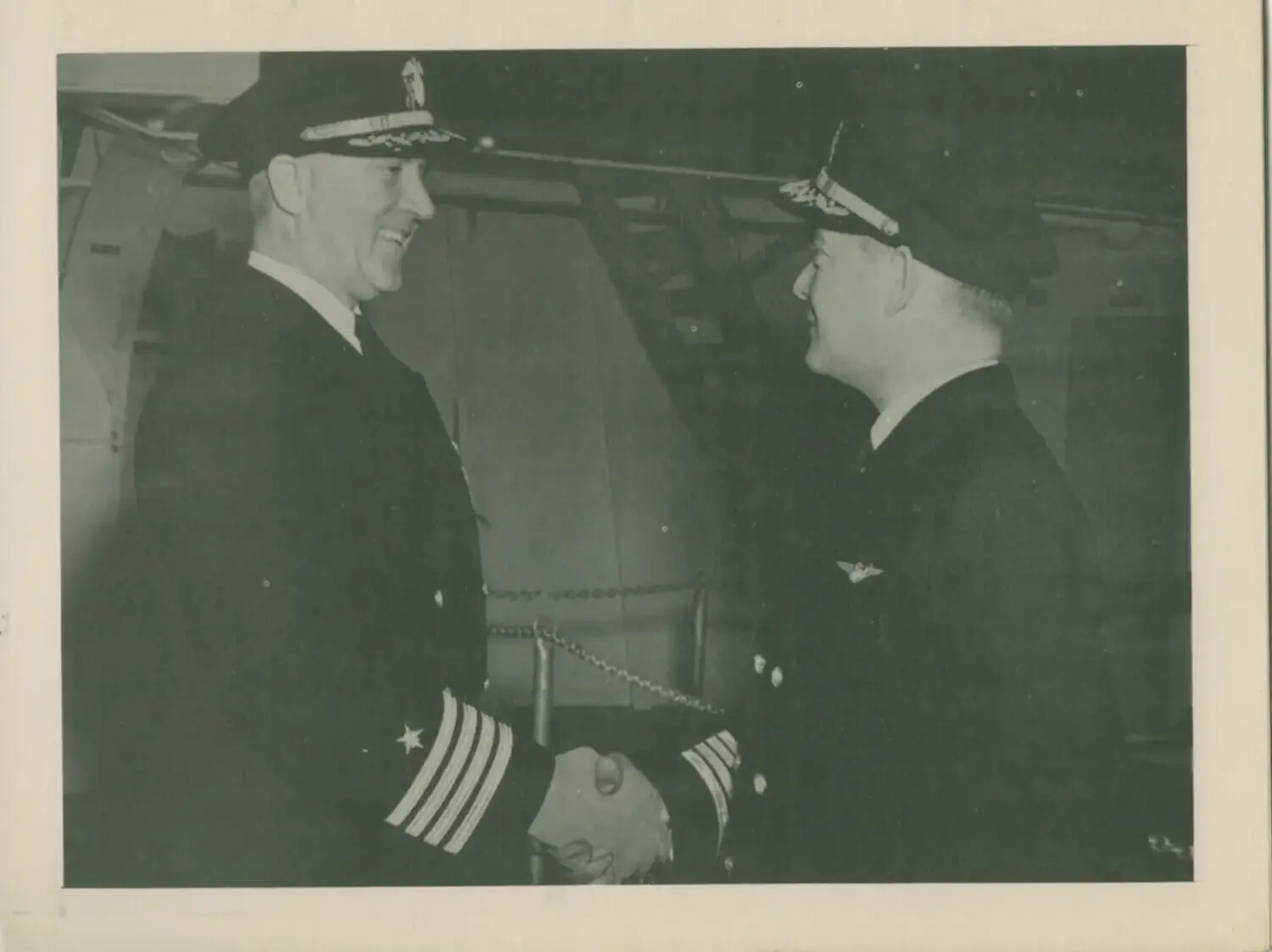 U.S. Navy Officers Shaking Hands Aboard USS Petrof Bay (CVE-80), Likely Change of Command Ceremony