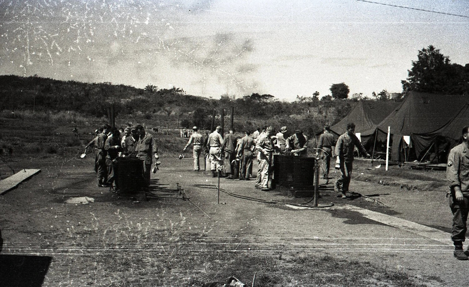 Soldiers Lined Up at Mess Kit Wash Stations, U.S. Army Camp, Luzon, Philippines, WWII