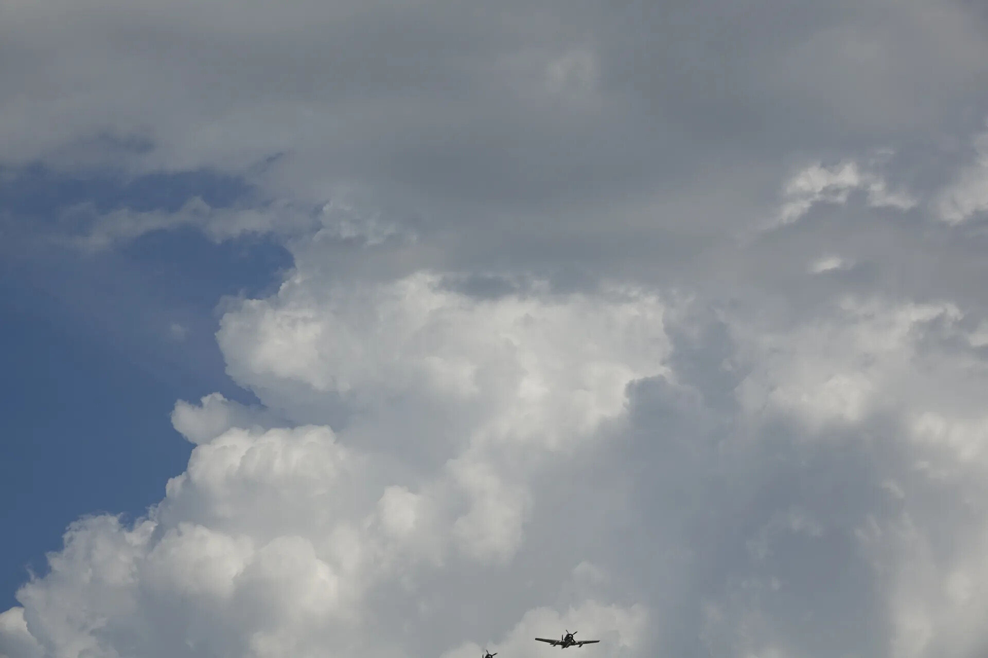 Warbird Pair in Formation Beneath Cumulus Clouds, May 2019 Airshow Event