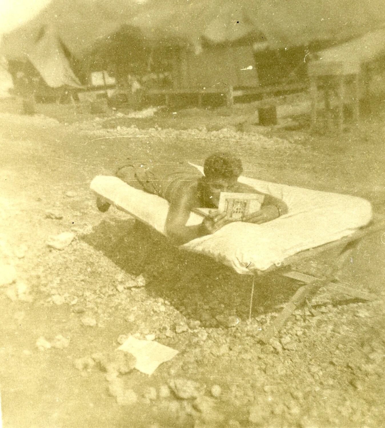 Airman Reading on a Cot, 345th Bomb Group Encampment, Ie Shima, WWII