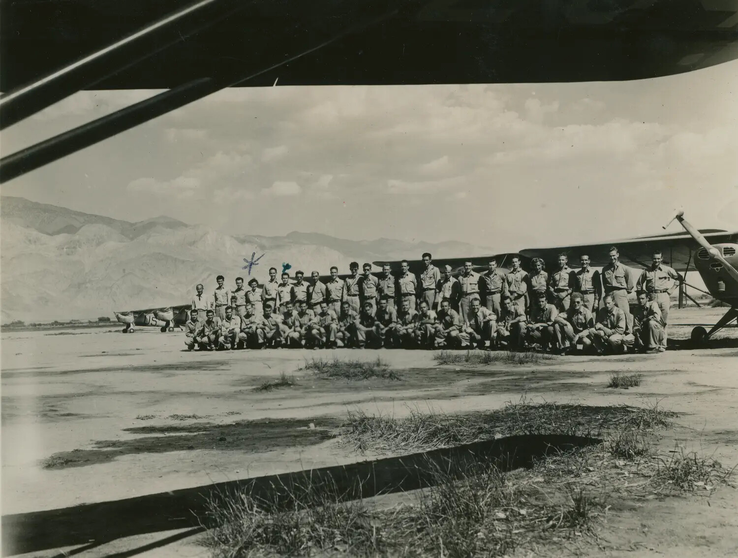 Squadron Group Portrait with Liaison Aircraft, Desert Airfield, Edward P. McAleer Collection