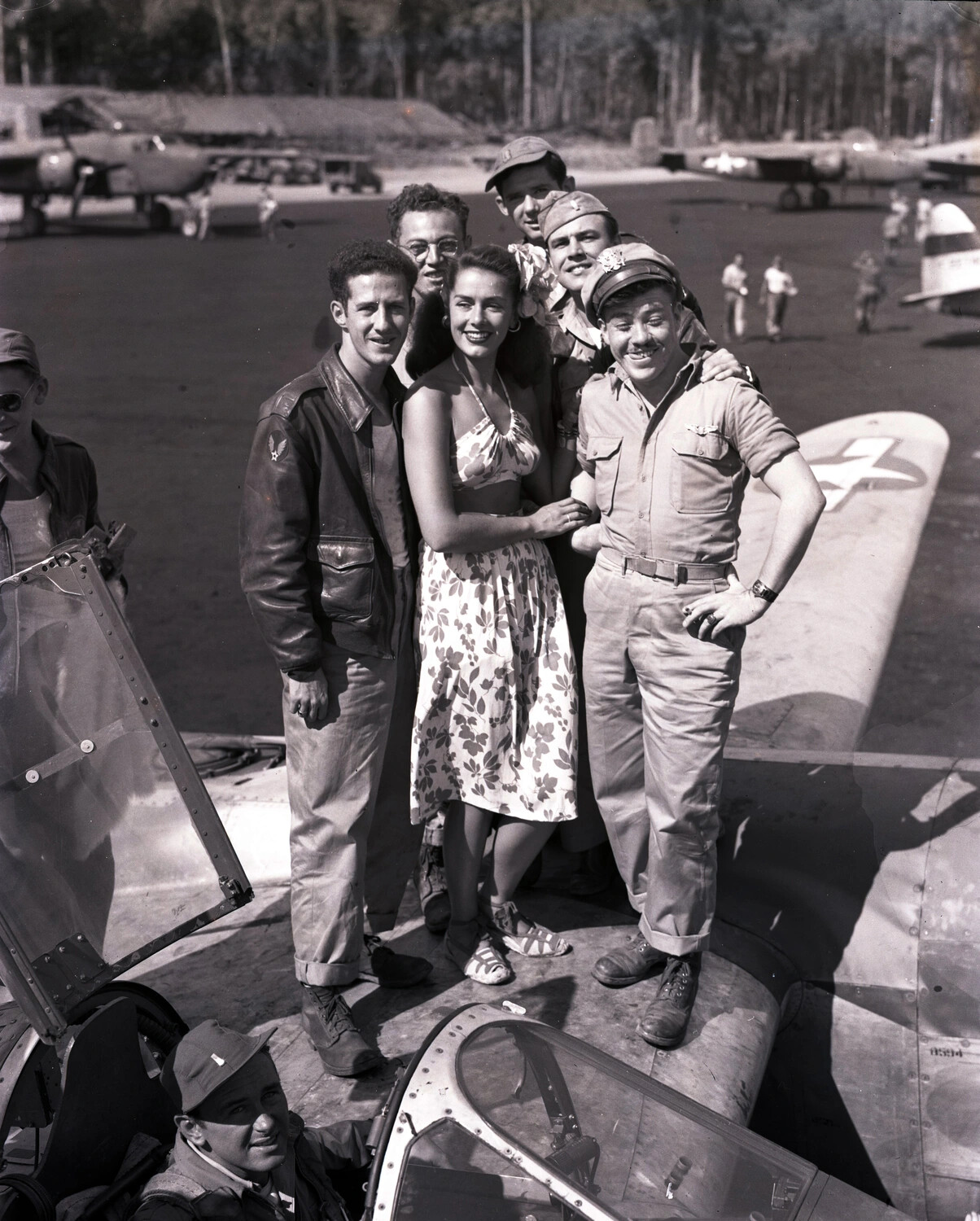 Group Portrait of Aircrew and Civilian Visitor on Fighter Aircraft Wing, Forward Airfield, Likely China-Burma-India Theater
