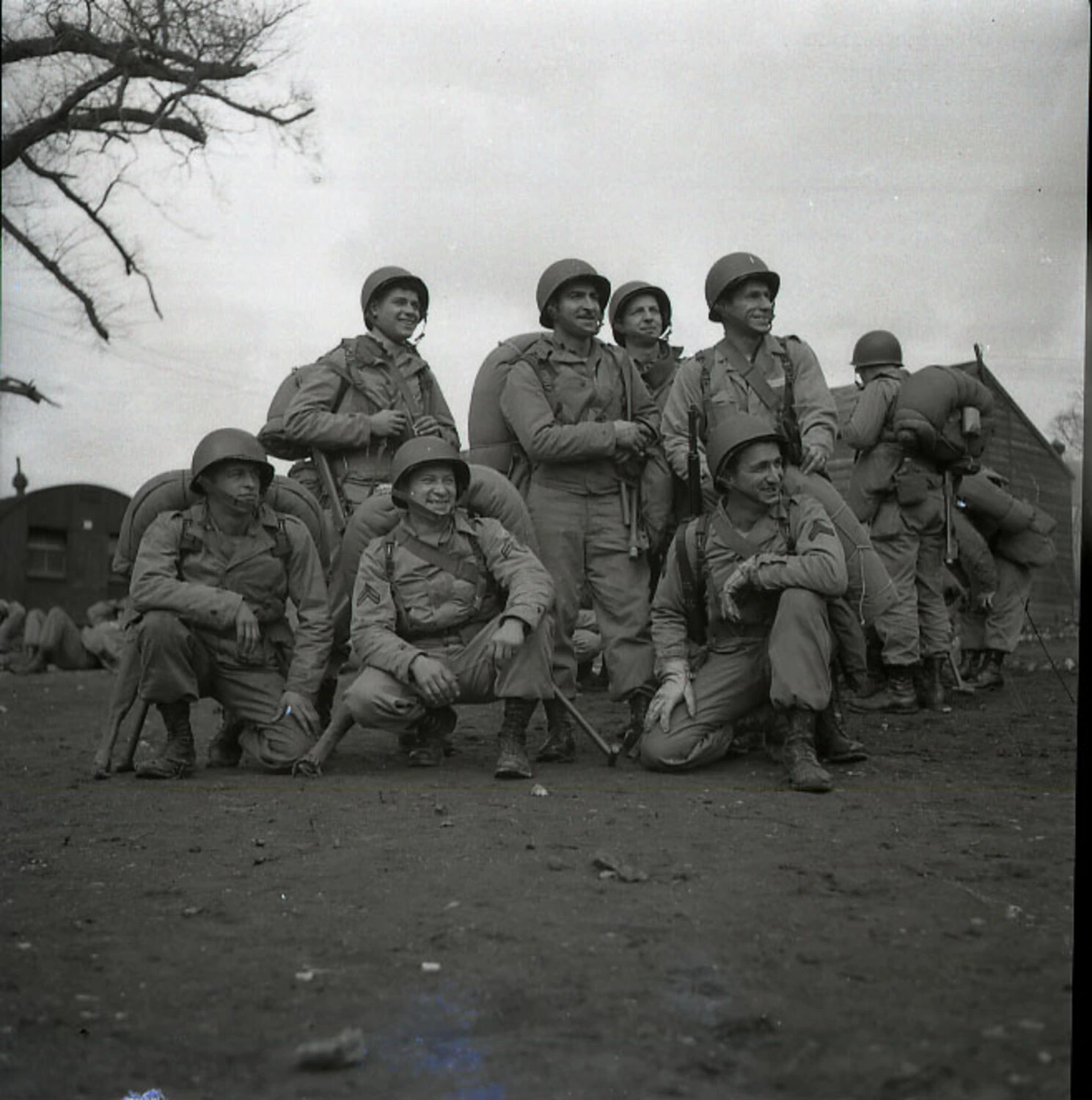Group Portrait of US Airborne Paratroopers in Field Gear Outside Barracks Huts, WWII European Theater