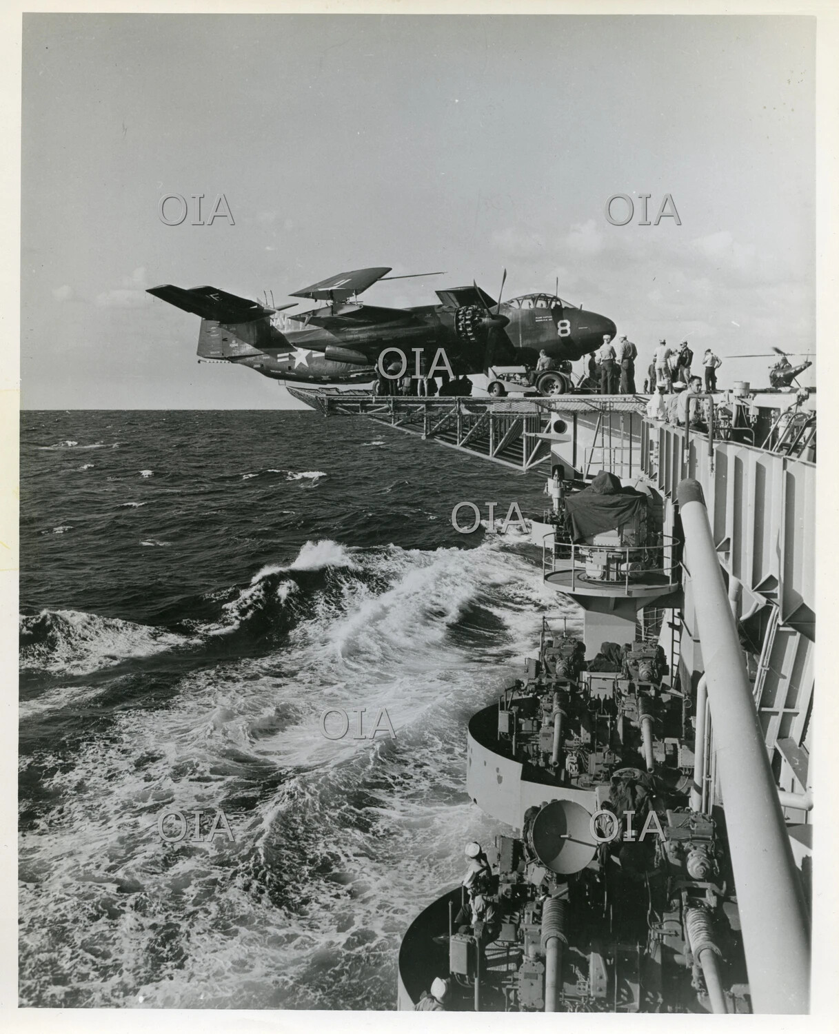 Twin-Engine U.S. Navy Carrier Aircraft on Deck-Edge Elevator with Gun Crews and Rough Seas