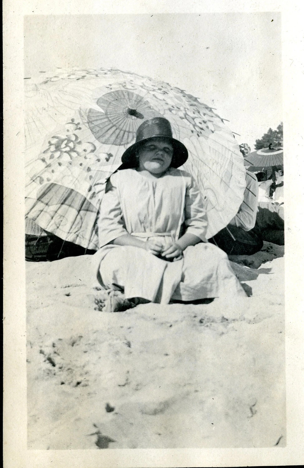 Young Girl Seated on a Beach Beneath a Decorative Parasol, c. 1918-1922