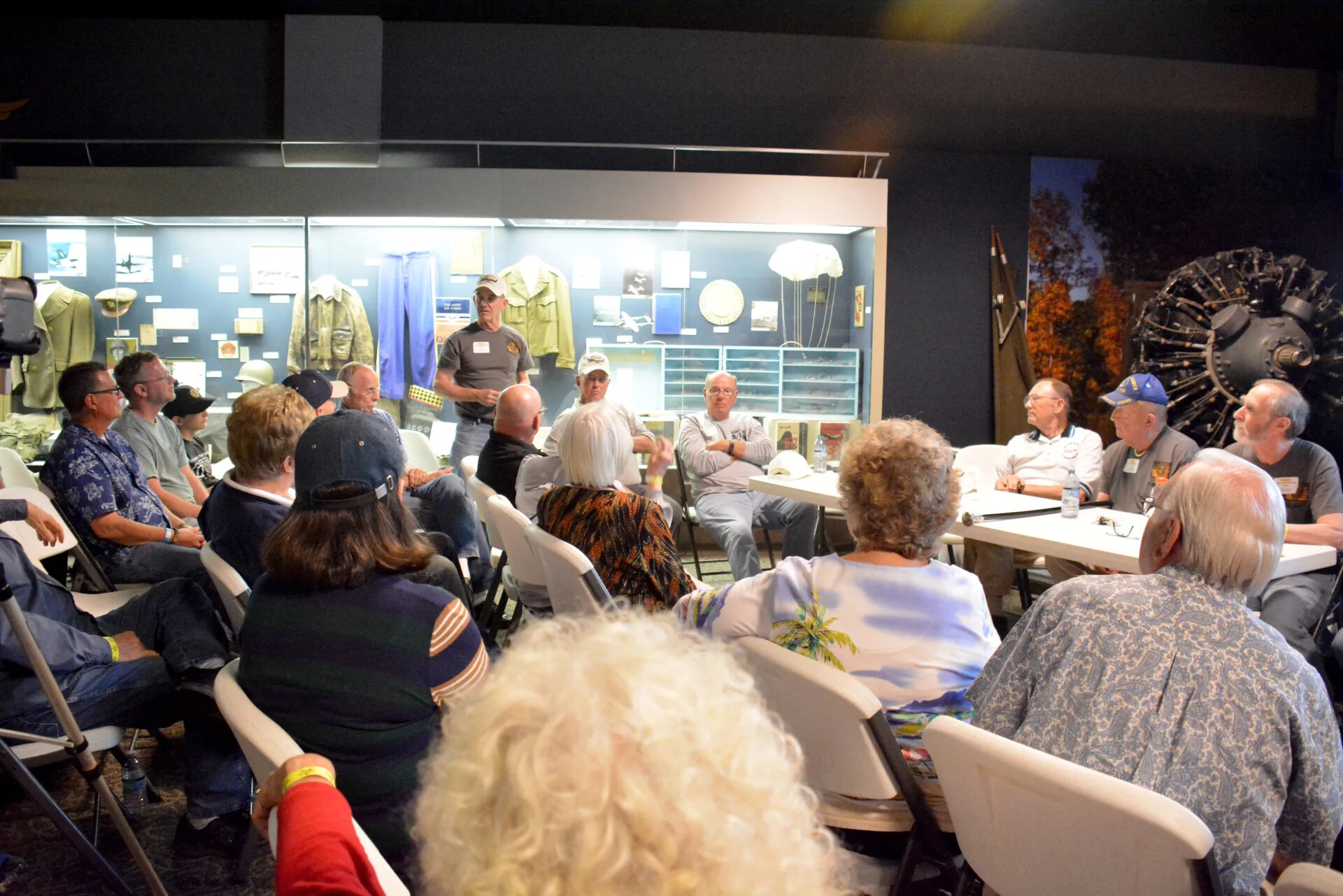 Veterans' Reunion Meeting, Aviation Museum Exhibit Hall — Group View with Adjacent Table