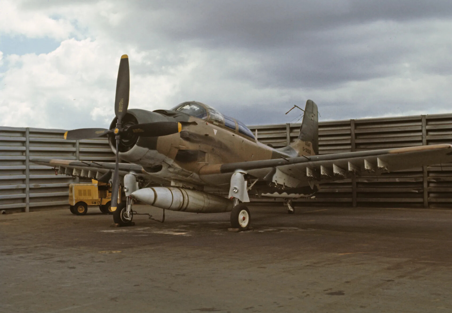 Douglas A-1 Skyraider Parked in Revetment with Ordnance and Drop Tank, Southeast Asia, Vietnam War Era