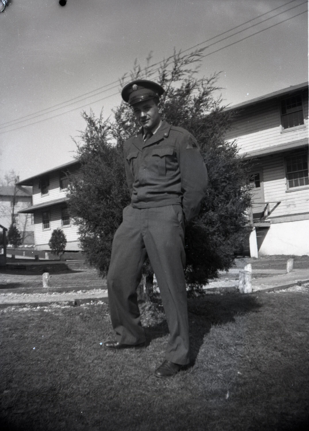 Non-Commissioned Officer Posed in Service Dress Uniform Before Barracks Building