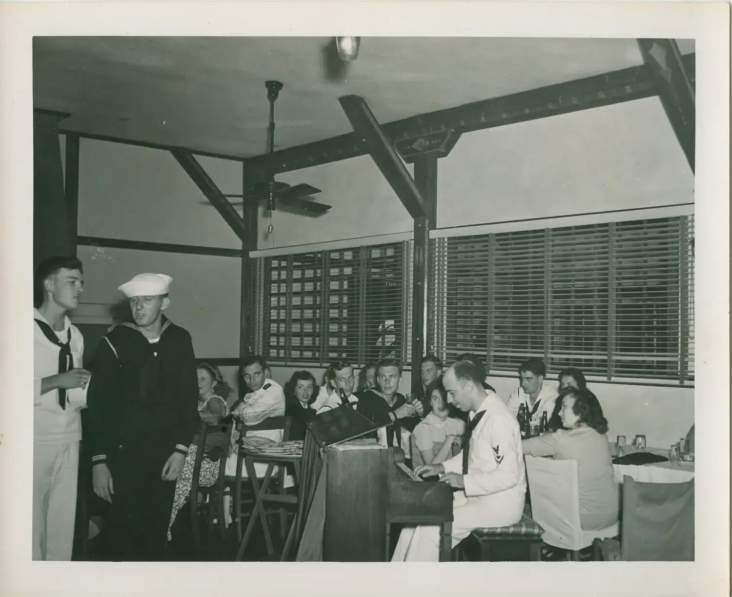 U.S. Navy Sailors and Guests at a Piano Sing-Along Party, USS Petrof Bay (CVE-80) Collection