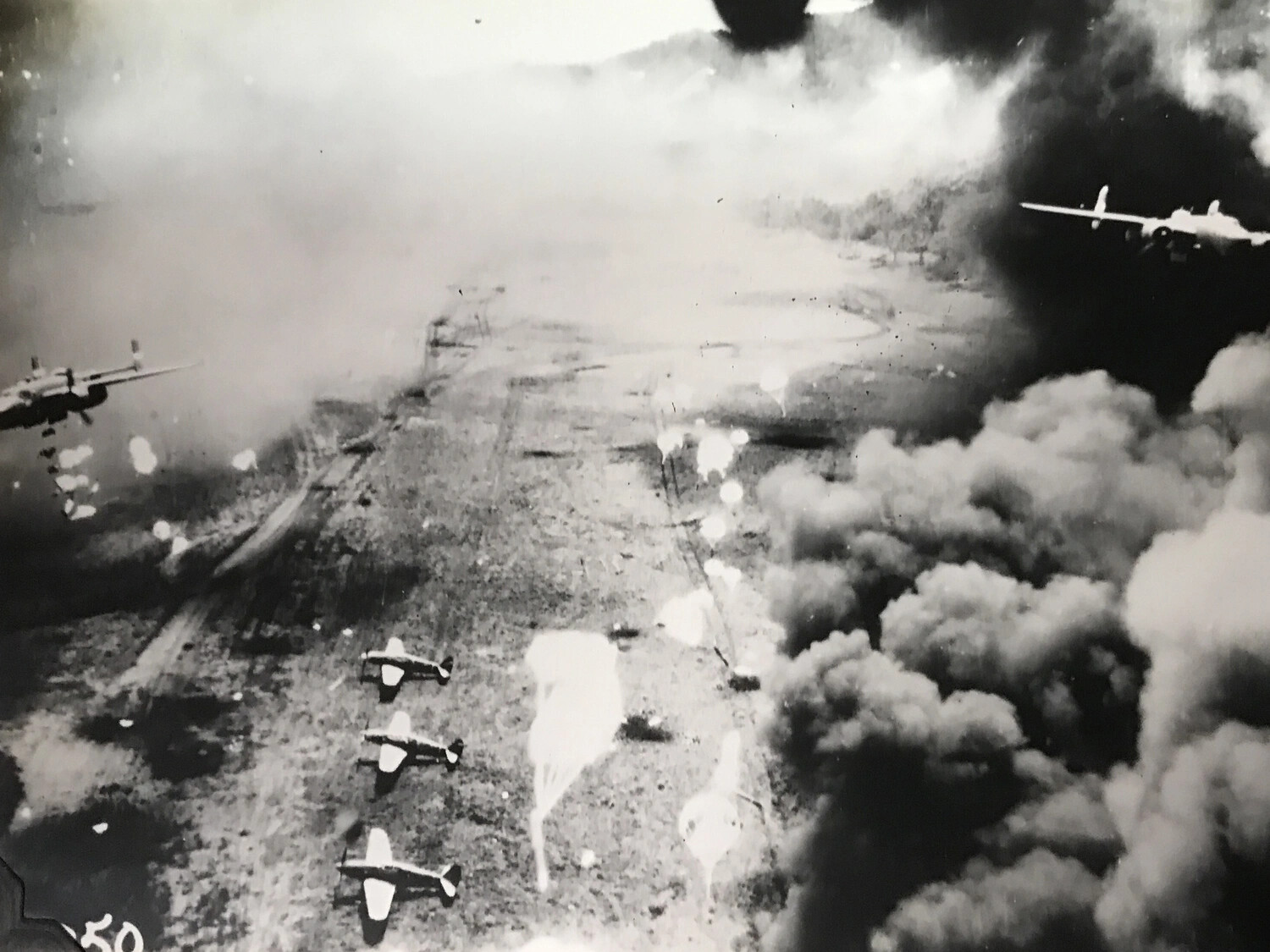 Low-Altitude Strike Photograph: Two B-25 Mitchells Amid Smoke, Dagua Airfield Raid