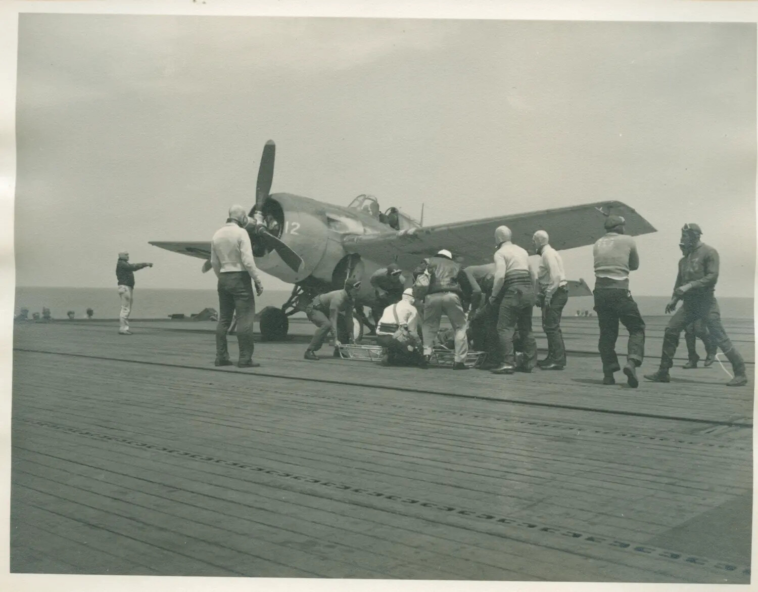 Flight Deck Crew Attending Fighter Aircraft Aboard USS Petrof Bay (CVE-80)