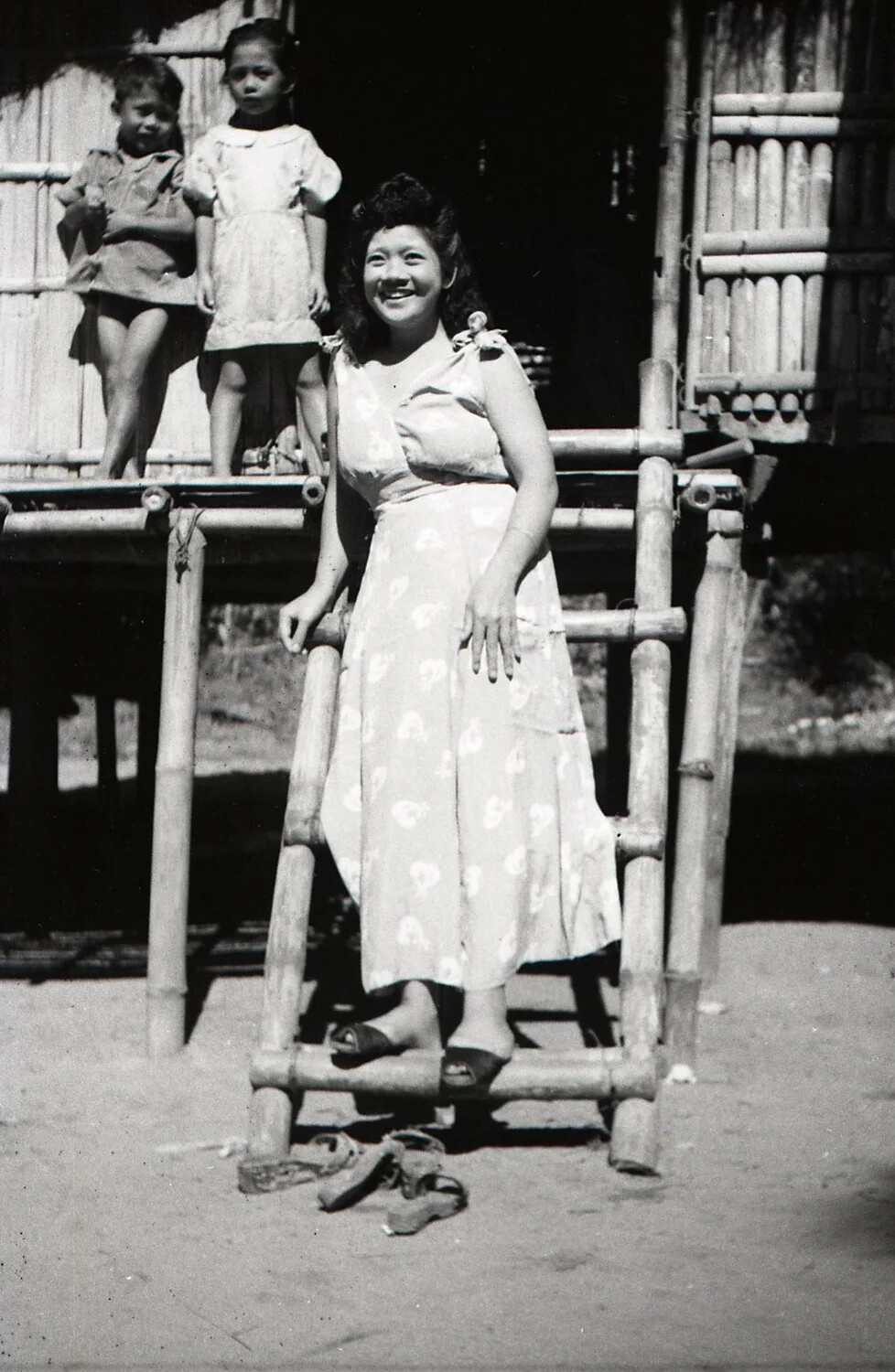 Young Filipino Woman Descending Bamboo Ladder, Luzon, Philippines, WWII Era