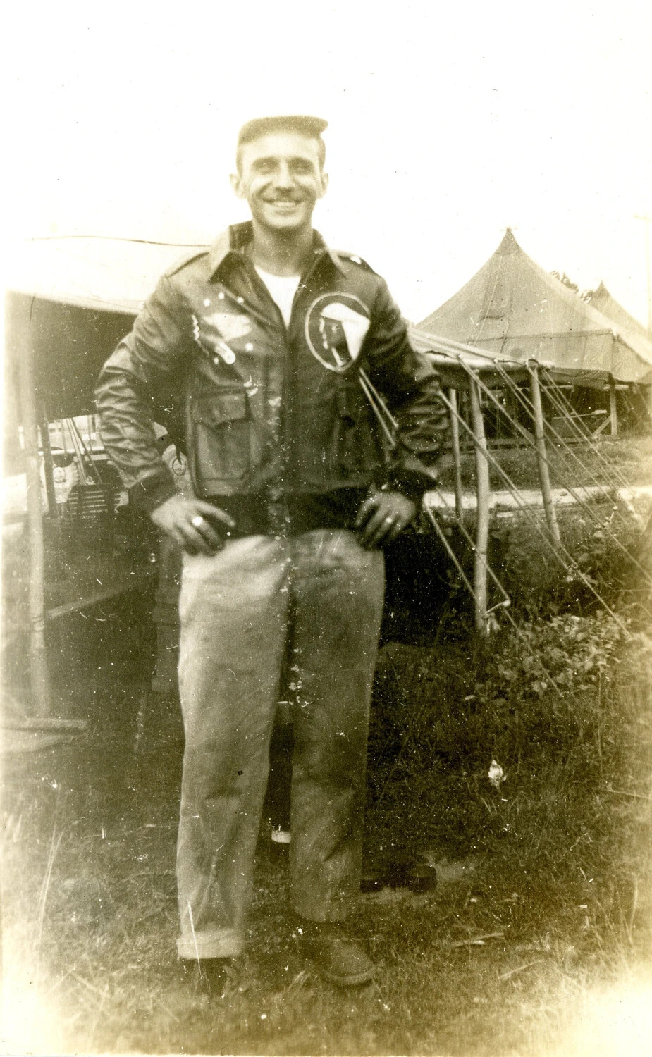 Airman in Squadron-Patched A-2 Flight Jacket at Tent Encampment