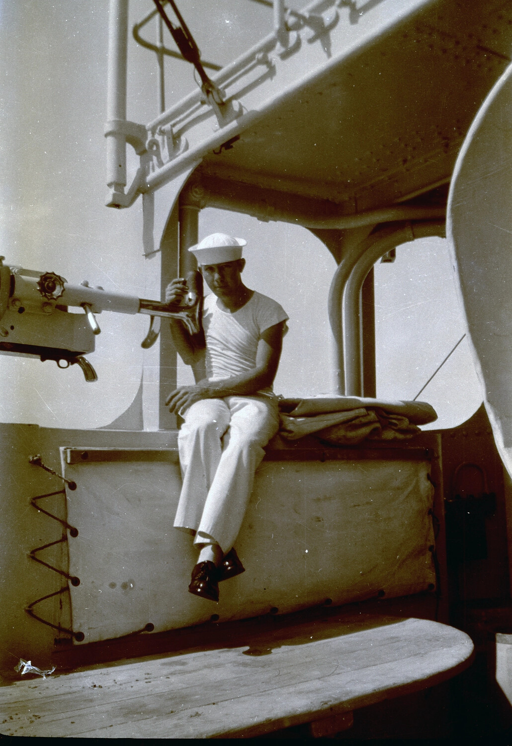 U.S. Navy Sailor Seated Beside Deck Gun Aboard Warship, China Station, 1930s
