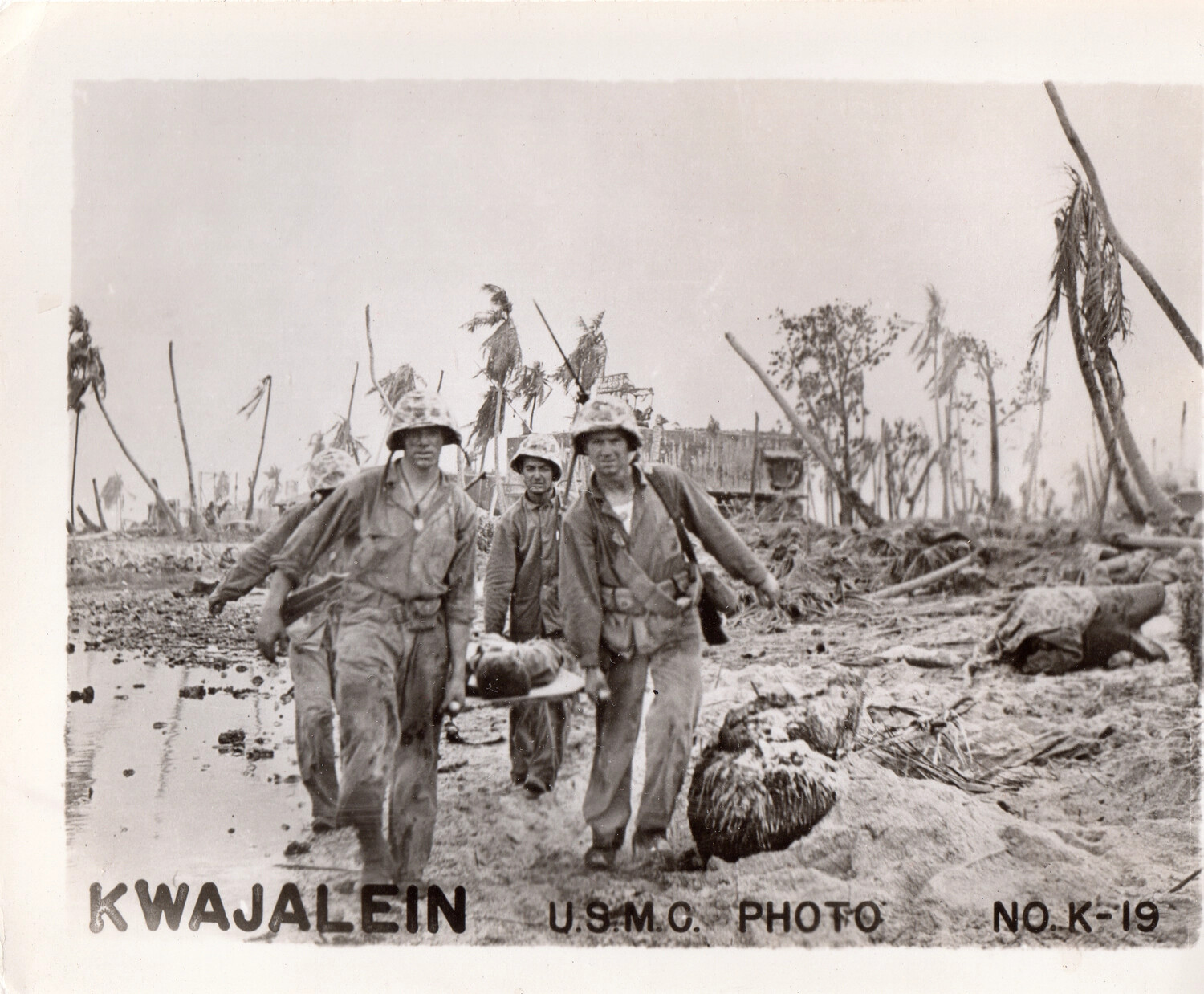 U.S. Marines Carrying a Casualty on a Stretcher Through the Battle-Scarred Terrain of Kwajalein, Marshall Islands, 1944