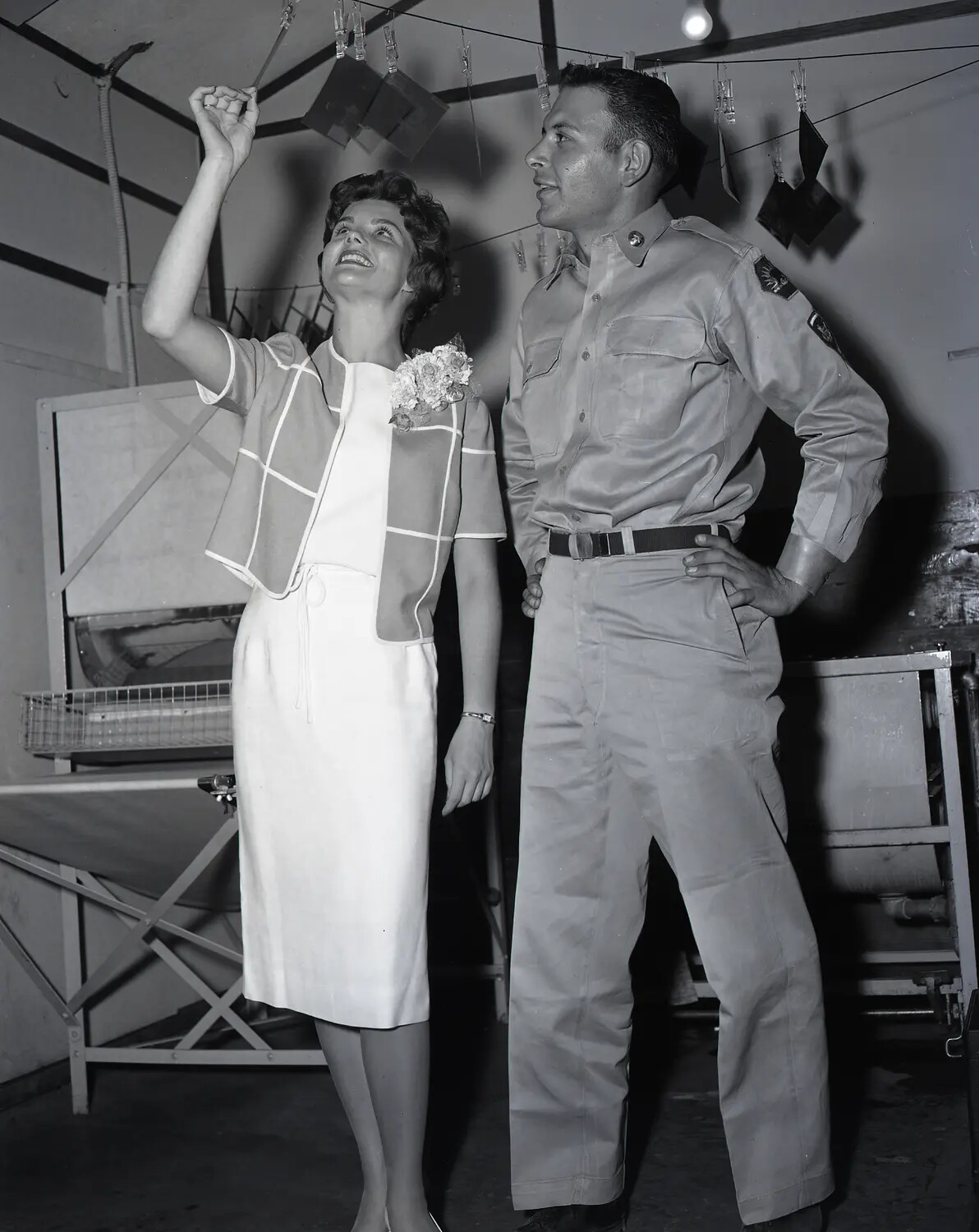 Pageant Representative and National Guard Serviceman Examining Film Negatives in Photo Lab