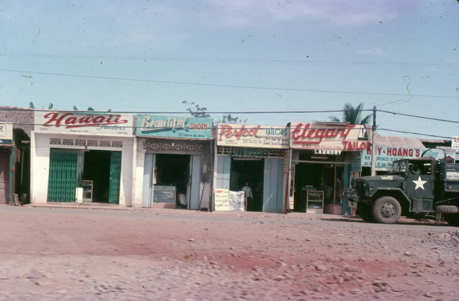 Row of Tailor Shops and U.S. Army Truck, Vietnamese Town Near Bien Hoa, 1965