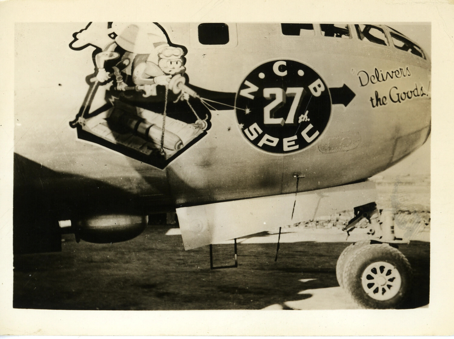 Nose Art "Delivers the Goods!" with 27th Special Naval Construction Battalion Insignia on a USAAF Transport Aircraft, World War II