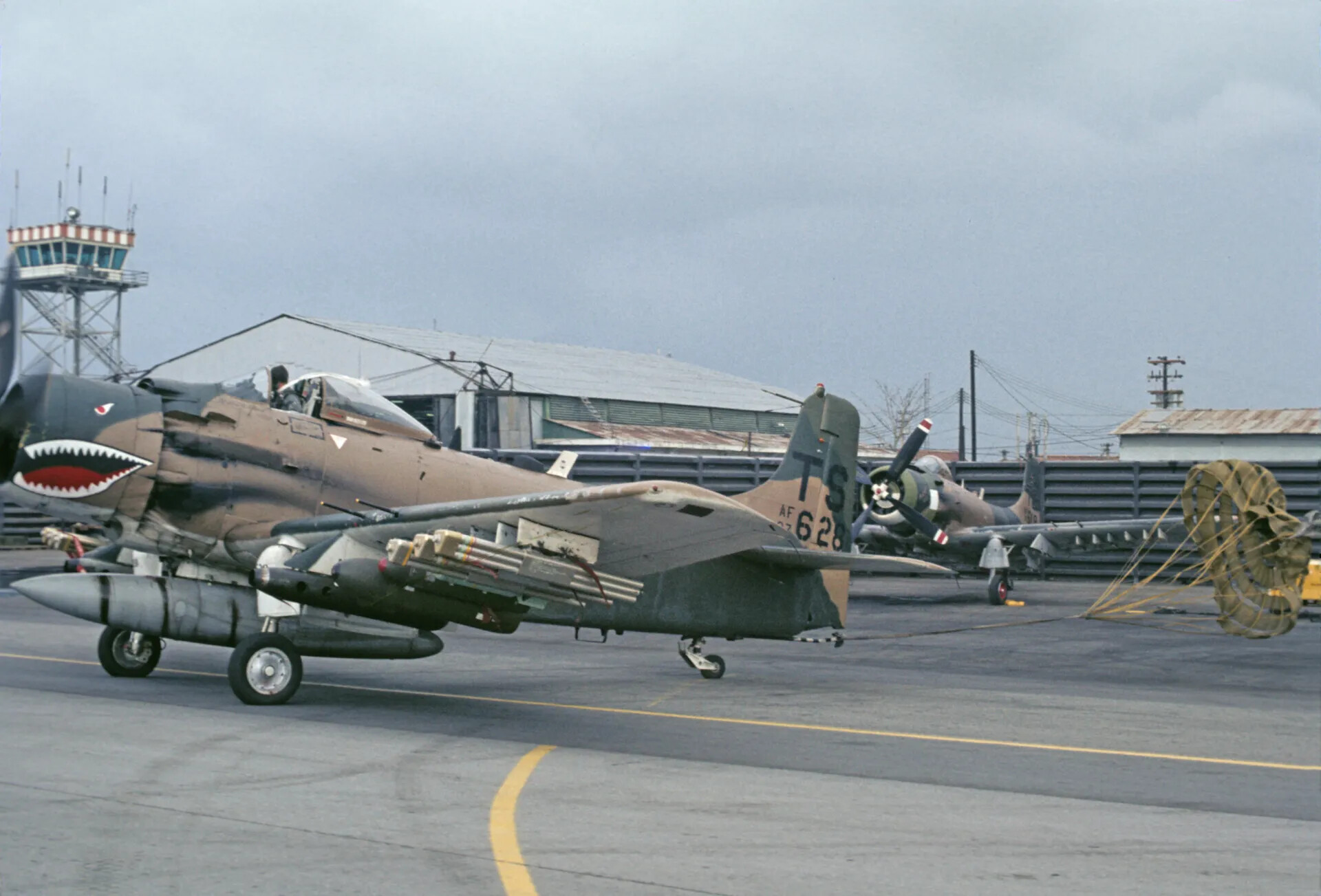 A-1 Skyraider with Shark-Mouth Nose Art Deploying Drag Chute on Landing Rollout, Vietnam-Era Airbase