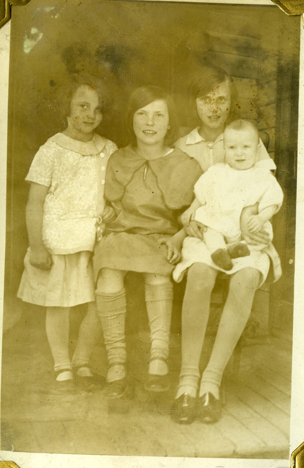 Group Portrait of Four Children on a Porch, Manila Photo Album