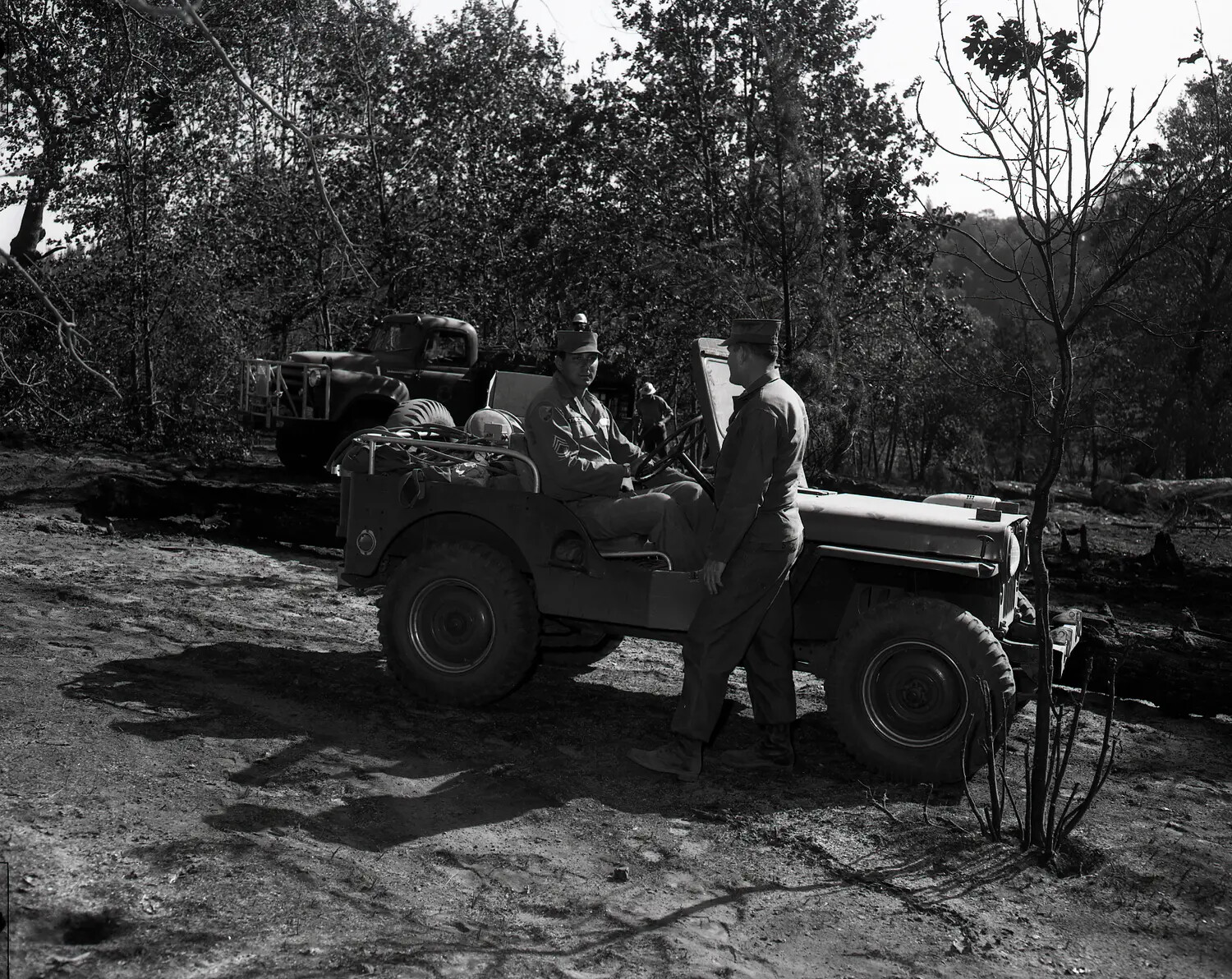 National Guard Personnel Conferring at Jeep, Wooded Field Site