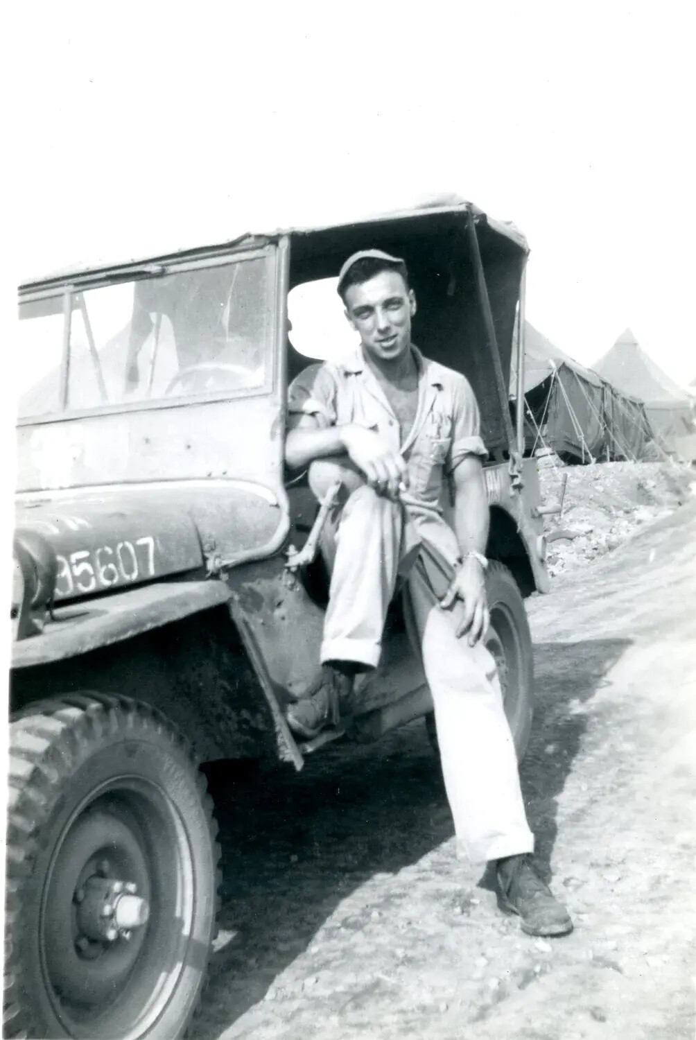 Marine Seated in Jeep Doorway at Tent Camp, Pacific Theater, WWII