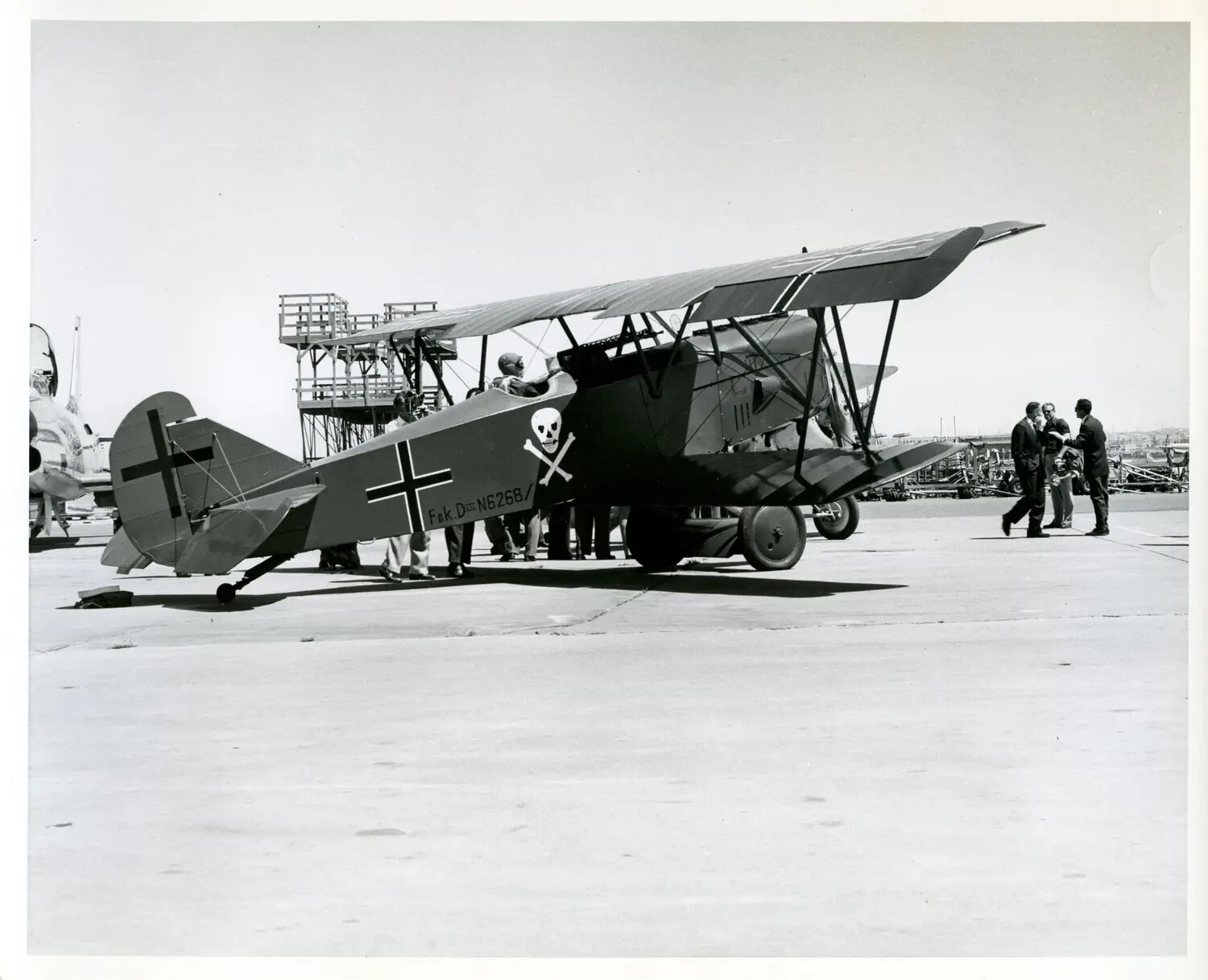 Fokker D.VII WWI Fighter Replica (Registration N6268) on Modern Airfield Ramp, Skull-and-Crossbones Nose Art