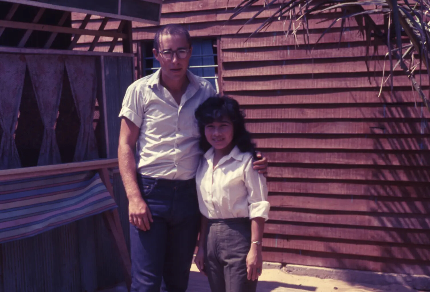 Personal Portrait: American Man and Young Vietnamese Woman Outside Wooden House, Vietnam War Era