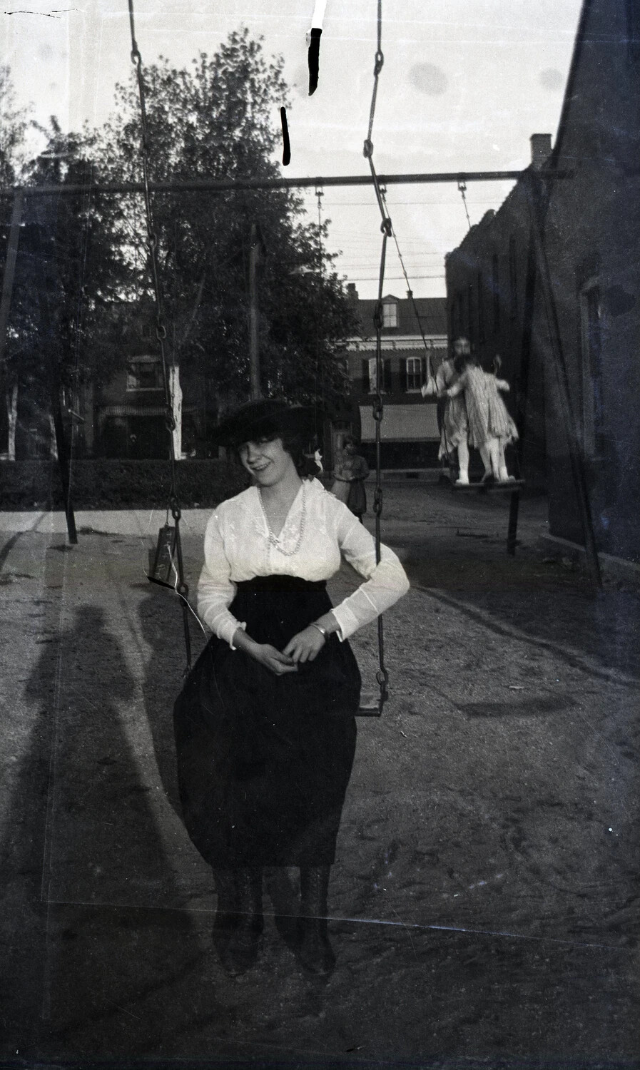 Young Woman on Playground Swing, WWI-Era European Street Scene