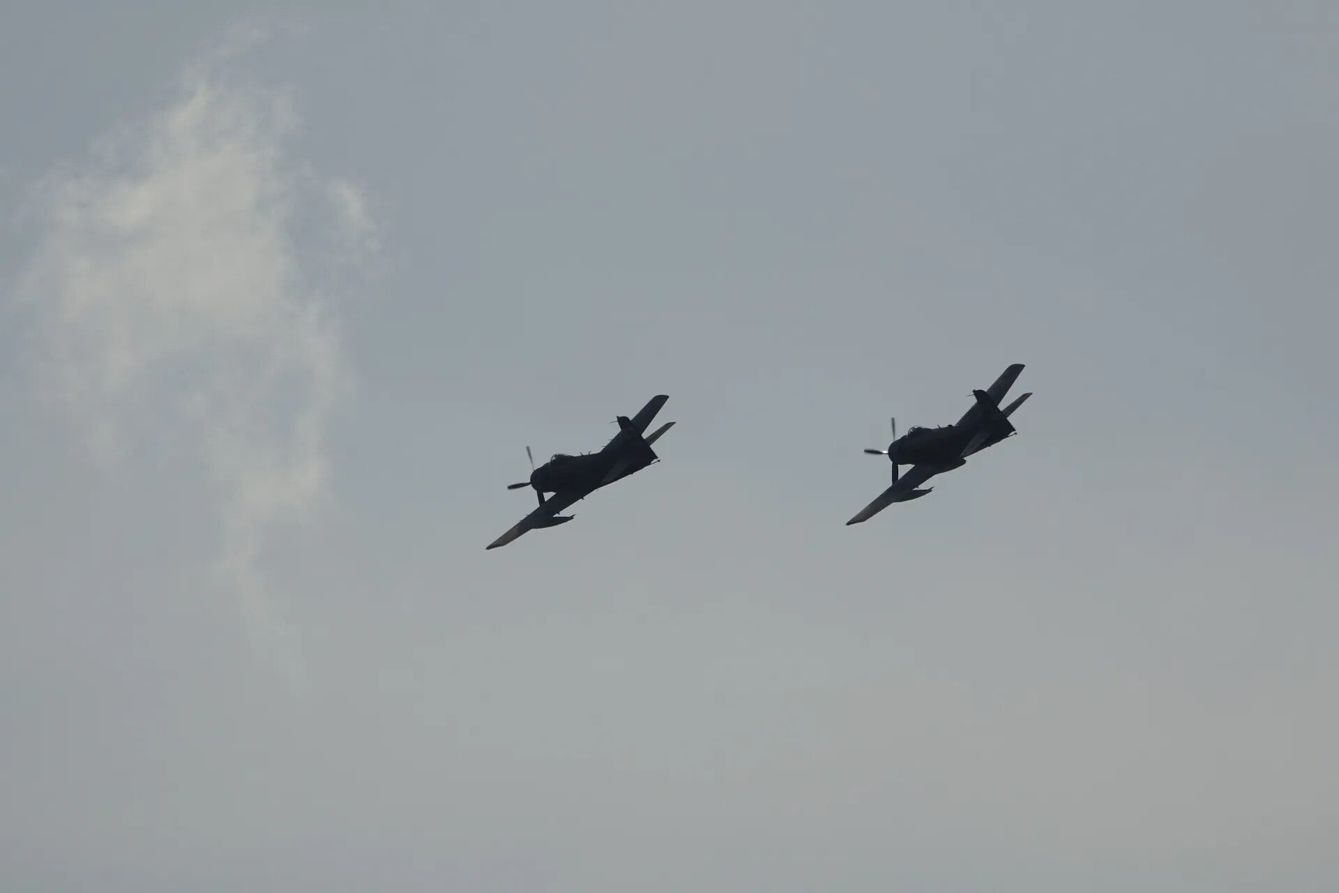 Two A-1 Skyraiders in Formation Break, Silhouette Against Overcast Sky — May 2019 Air Show