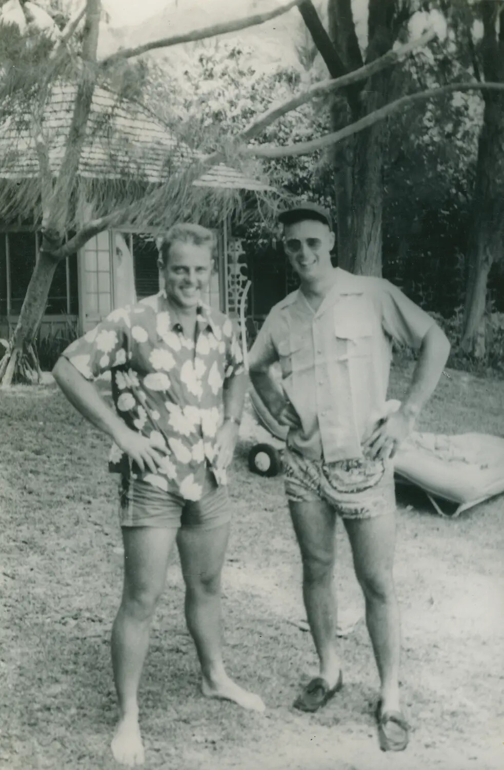 Two Men in Tropical Vacation Attire at Thatched-Roof Cabana, McAleer Collection